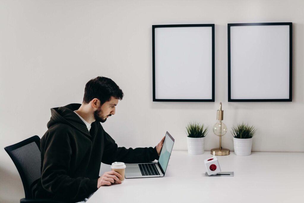 Man sitting at a computer evaluating the competition for his blog idea.