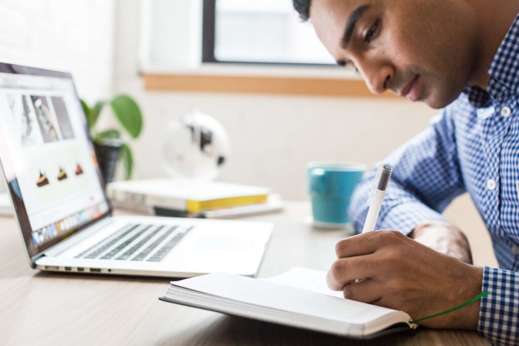 Man sitting at a computer thinking about how to start a blog.